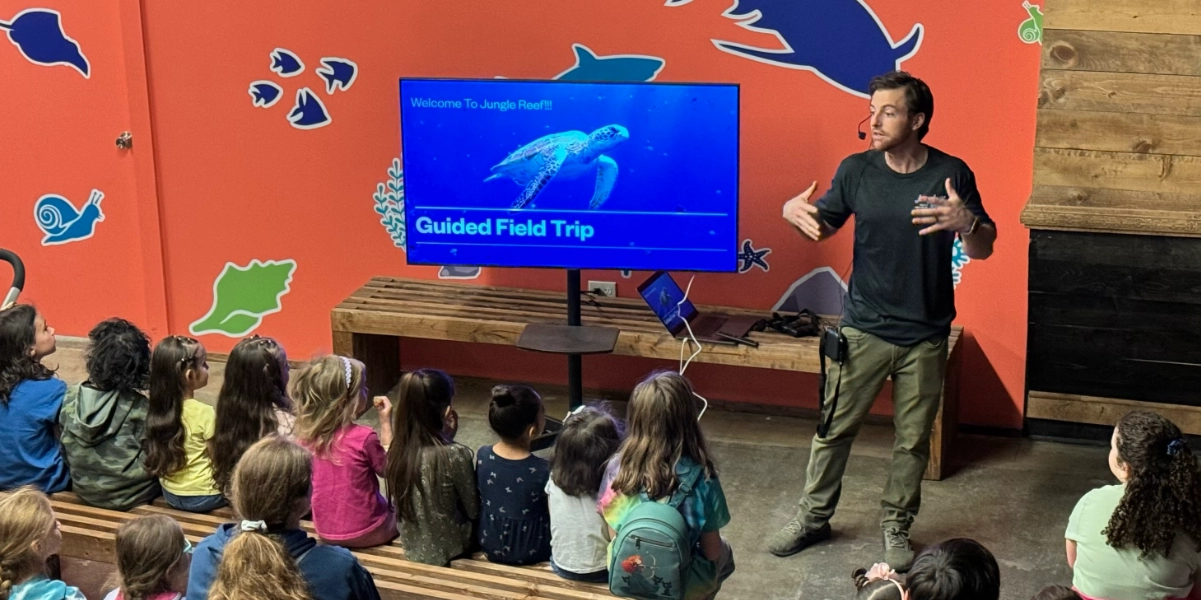 a man presenting a guided tour to children